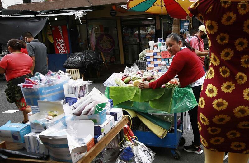 epa09258608 A street vendor walks with her products on a street in San Salvador, El Salvador, 09 June 2021. El Salvador will allow bitcoin to be used as a legal tender exchange currency, after the approval of the implementing law, despite the risk that the Central American country will become a tax haven that encourages money laundering and tax evasion.  EPA/MIGUEL LEMUS