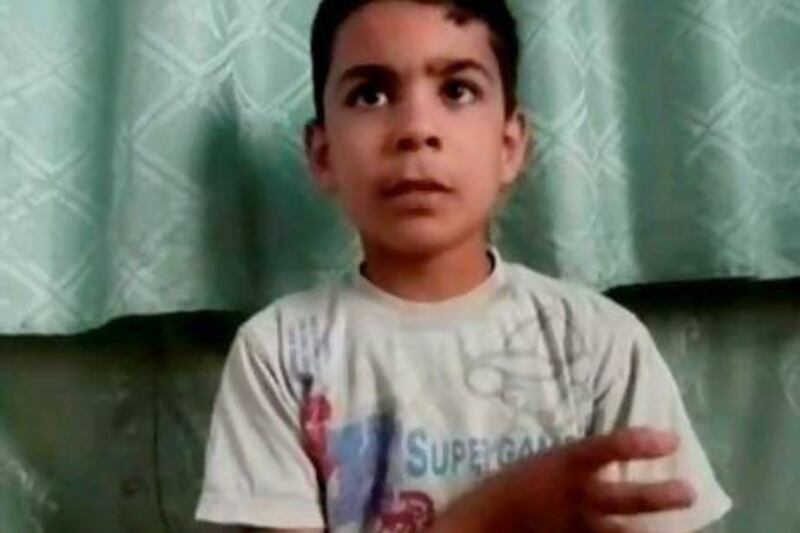 This image made from amateur video, purports Ali Al Sayed, 11, who survived the Houla massacre by pretending to be dead. Shaam News Network via AP video / AP Photo