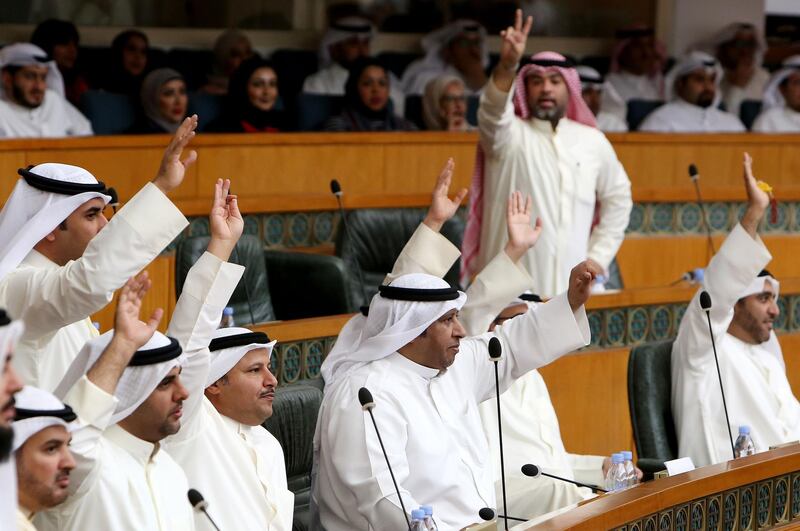 Kuwaiti MPs react during a parliament session at Kuwait's National Assembly in Kuwait City on March 6, 2018. / AFP PHOTO / YASSER AL-ZAYYAT