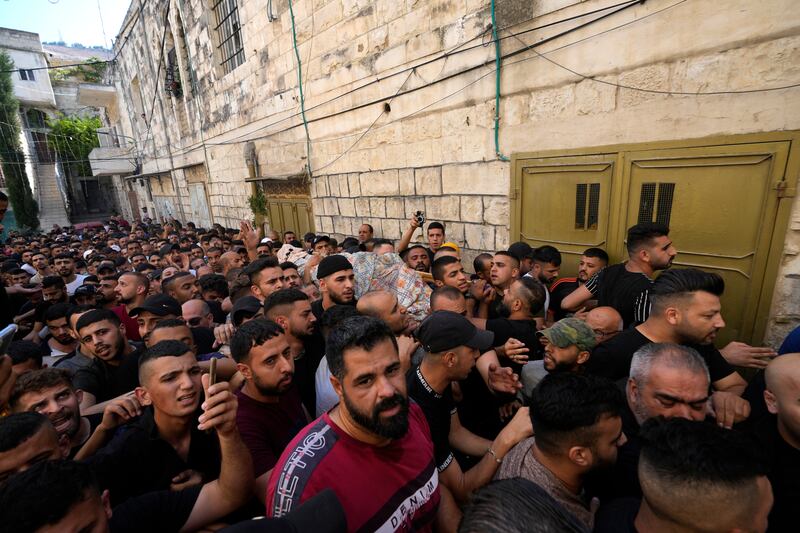 Palestinians carry the body of Islam Sabouh. Israeli police said forces encircled the home of Ibrahim Al Nabulsi, who they say was wanted for a string of shootings in the West Bank earlier this year, and that Al Nabulsi and Sabouh were killed in a shootout.  AP Photo