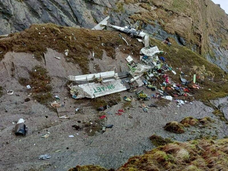 An aerial view of the wreckage of the plane under a steep cliff in the mountains. Reuters