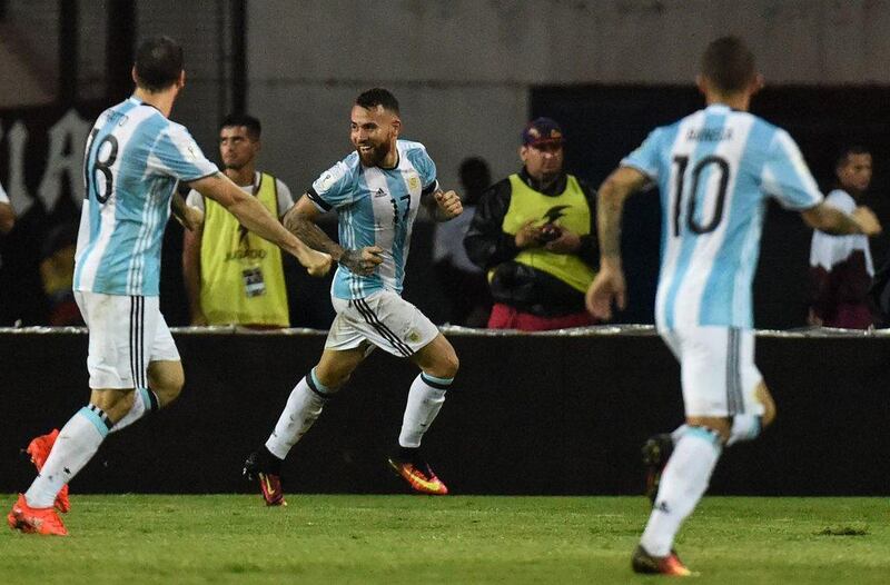 Nicolas Otamendi, centre, celebrates after scoring Argentina's late equaliser against Venezuela. Juan Barreto / AFP

