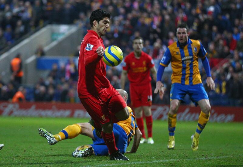 MANSFIELD, ENGLAND - JANUARY 06:  Luis Suarez of Liverpool appears to control the ball with his hand during the FA Cup with Budweiser Third Round match between Mansfield Town and Liverpool at One Call Stadium on January 6, 2013 in Mansfield, England.  (Photo by Clive Mason/Getty Images)