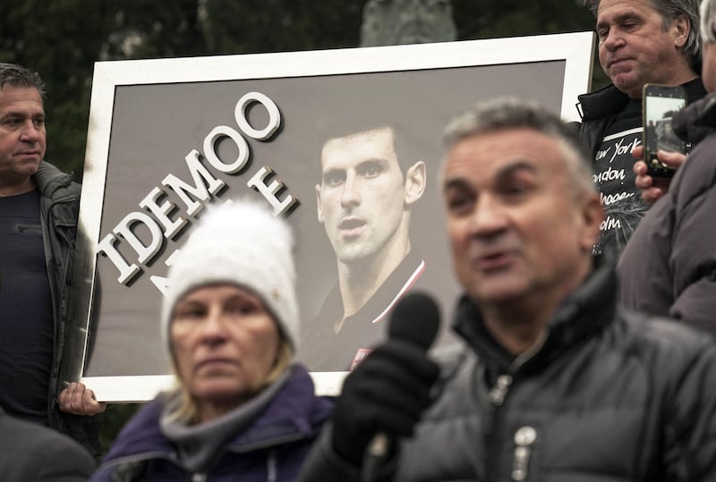 Serbian tennis player Novak Djokovic's father Srdjan Djokovic (R) speaks flanked by his wife Dijana Djokovic (L), as they take part in a rally in front of Serbia's National Assembly, in Belgrade. AFP