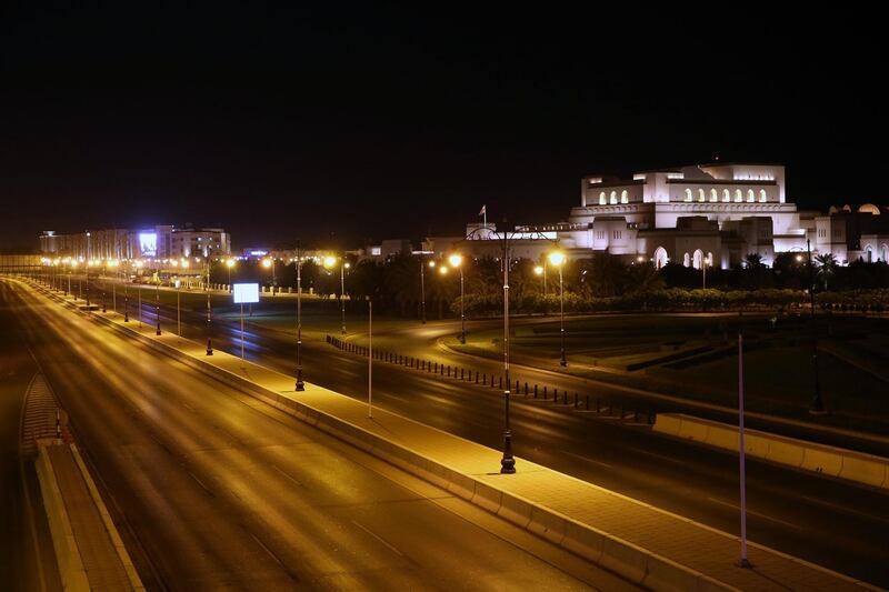 An empty road is pictured with the Muscat Opera House in the Omani capital Muscat amid a lockdown to prevent the spread of the coronavirus COVID-19 on July 27, 2020.  / AFP / MOHAMMED MAHJOUB
