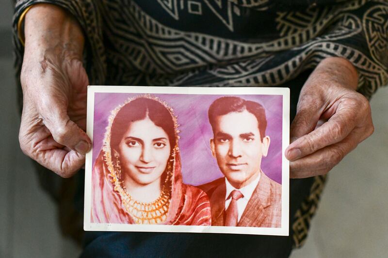 Dr Rafeeya Sultan Pasha shows a photograph of her with husband with Mohammed Sultan Pasha on their wedding day in Karachi. Khushnum Bhandari / The National