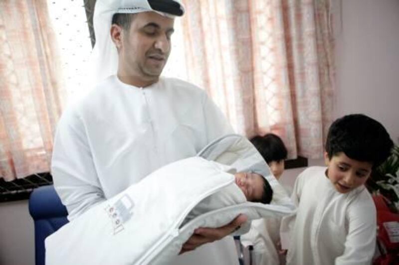 August 30, 2011 (Abu Dhabi) Abdulrahman al Zaabi, welcomes the birth of his fourth son Rashid, as his other sons Mohammed, 5, and Saif, 7, look on at the Corniche Hospital August 30, 2011. Rashid was the first baby born during  Eid al-Fitr. (Sammy Dallal / The National)