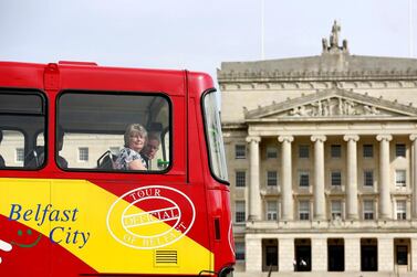 A tour bus makes its way past parliament buildings on the Stormont estate in Belfast, Northern Ireland. Reuters  