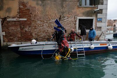 A group of scuba divers from Venice's gondolier association collect waste from the lagoon city's canals as part of a clean-up operation in Venice, Italy, December 1, 2019. REUTERS/Manuel Silvestri