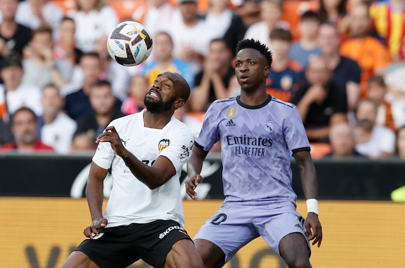 Valencia's defender Dimitri Foulquier (L) in action against Real Madrid's striker Vinicius Junior (R) during the Spanish LaLiga match between Valencia CF and Real Madrid at Mestalla stadium in Valencia, Spain, 21 May 2023.   EPA / Kai FORSTERLING