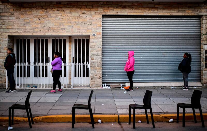 People line up outside a bank in the municipality of Jose C Paz, province of Buenos Aires during the lockdown in Argentina to slow the spread of the novel coronavirus COVID-19.  AFP