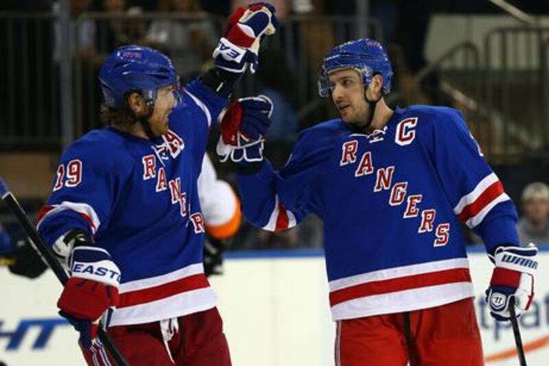 New York Rangers captain Ryan Callahan is congratulated by teammate Brad Richards (l).