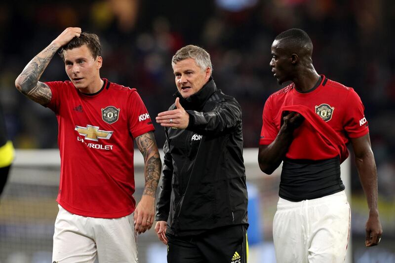 Ole Gunnar Solskjaer (centre) talks with Victor Lindelof (left) and Eric Bailly. EPA