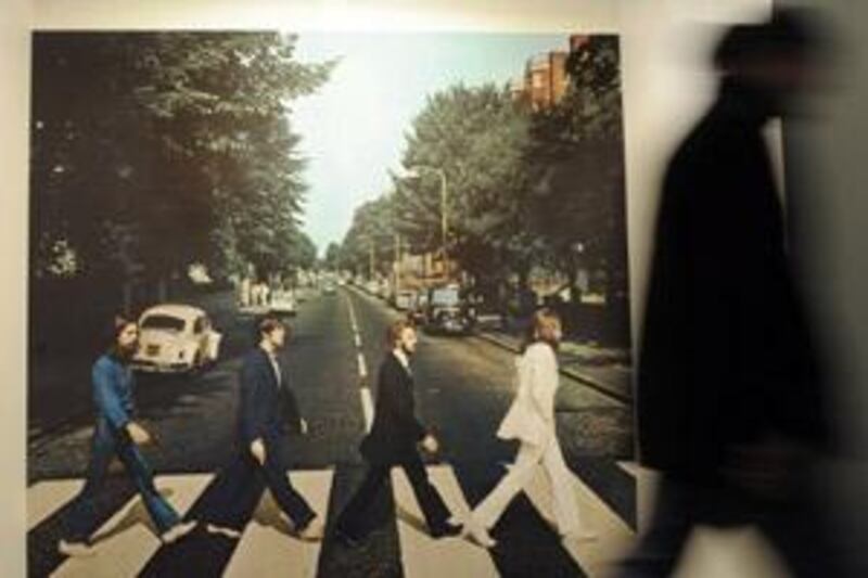 A visitor passes an oversized photo of Abbey Road during the opening of the Beatles Museum in Hamburg, Germany.