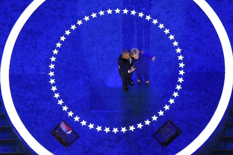 US president Barack Obama and Democratic presidential candidate Hillary Clinton wave to delegates after Mr Obama’s speech during the third day of the Democratic National Convention in Philadelphia. Mark J Terrill / AP Photo