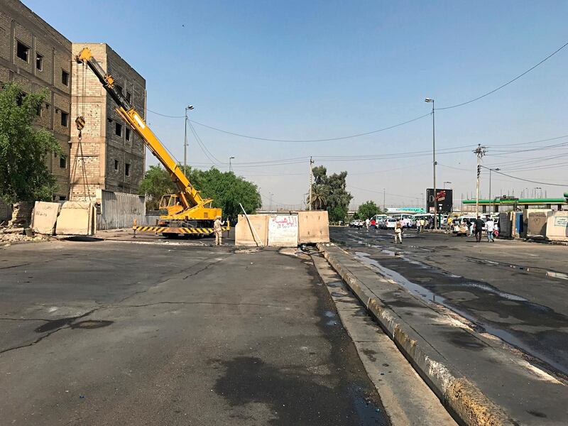 Iraqi security forces remove concrete blast walls that were cutting the streets in the protest site area of Baghdad, a day after calm was restored in the Iraqi capital. AP Photo