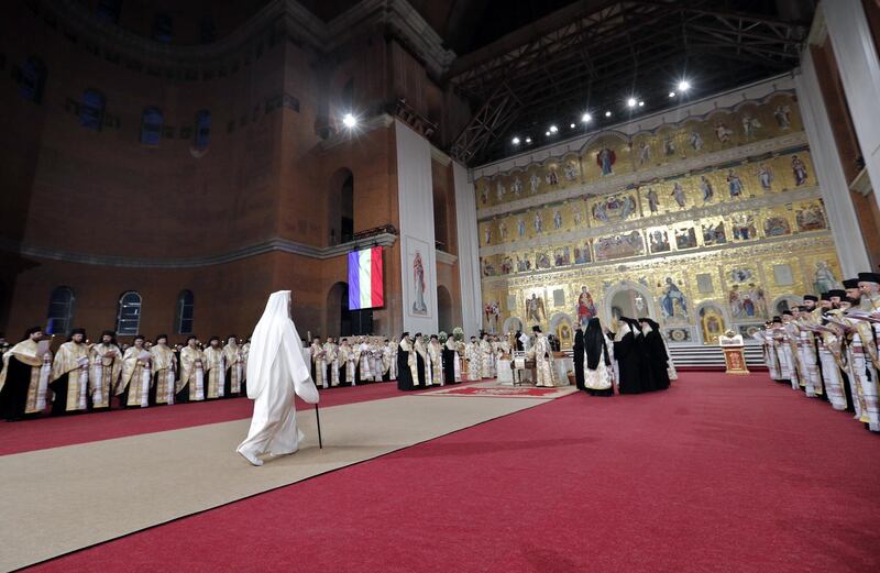 Romanian Orthodox Patriarch Daniel (left - in white) arrives for a mass dedicated to the nation's fallen heroes in Bucharest, Romania. EPA