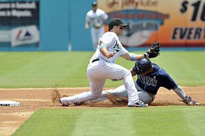 The Florida Marlins second baseman Dan Uggla, left, tags out Tampa Bay Rays' Carl Crawford.