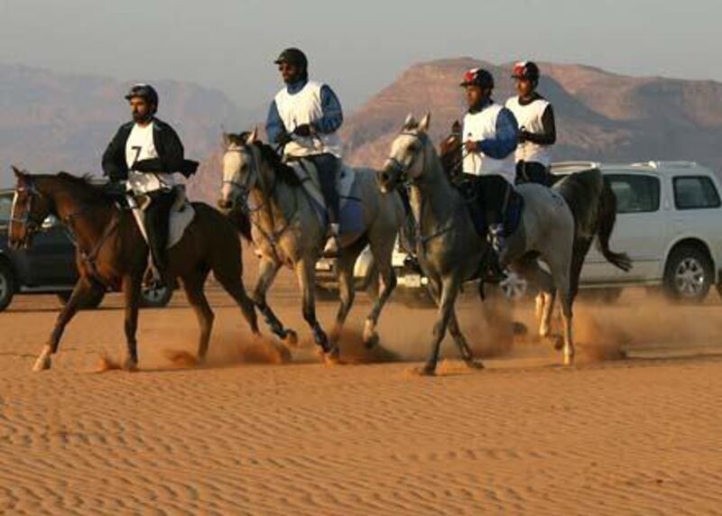 Dubai ruler Sheikh Mohammed bin Rashed al-Maktoum (L), who is also Emirati vice president and prime minister, takes part in a horse endurance race along with his sons in the Jordanian desert of Wadi Rum on November 14, 2008. AFP PHOTO/AWAD AWAD *** Local Caption ***  707312-01-08.jpg