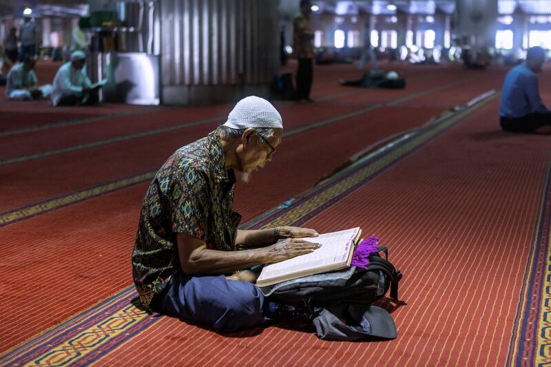 A man sits reading inside the Istiqlal Mosque in Jakarta. Bloomberg