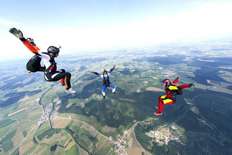 Three skydivers with GoPro cameras mounted on their helmets. Professional athletes and weekend warriors alike spend between $200 and $400 on these devices and other accessory mounts to record their actions. Oliver Furrer