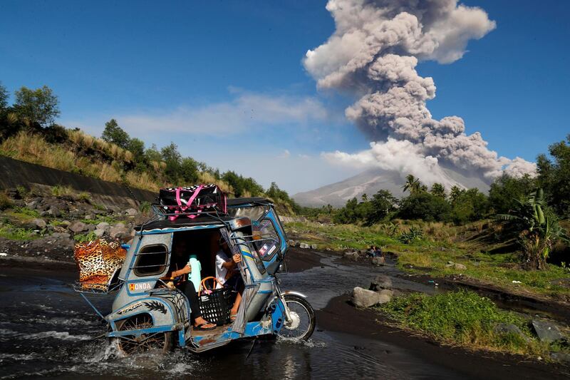 Filipino villagers escape to a safe area as the Mayon Volcano erupts anew in the town of Daraga, Albay province, Philippines. Francis Malasig / EPA