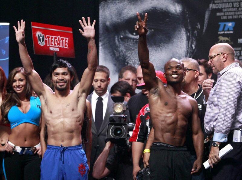 Boxers Manny Pacquiao and undefeated WBO welterweight champion Timothy Bradley wave to fans during an official weigh-in at the MGM Grand Garden Arena in Las Vegas, Nevada on Friday, April 11, 2014. Pacquiao will challenge Bradley at the arena on April 12, in a rematch of the June 2012 fight that Bradley won. Steve Marcus / Reuters 