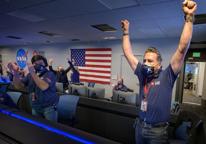 Members of Nasa's Perseverance rover team react in mission control after receiving confirmation the spacecraft successfully touched down on Mars, at Nasa's Jet Propulsion Laboratory in Pasadena, California on February 18, 2021. Nasa via Reuters