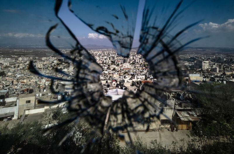 The city of Jenin in the occupied West Bank, seen through a bullet hole as the Isarel-Gaza war rages on. AFP