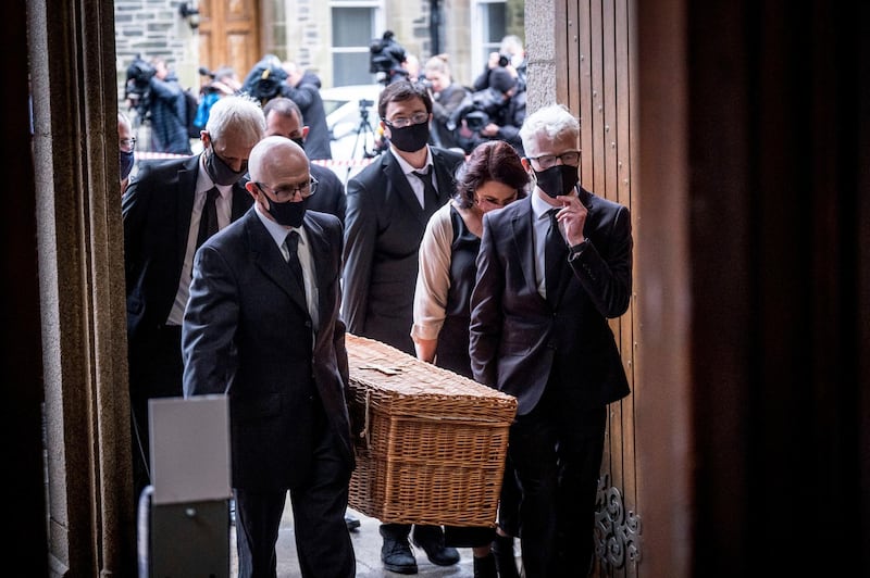 Members of the family carry the coffin of John Hume into St Eugene's Cathedral. AP Photo