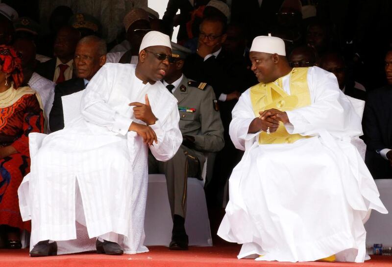 Senegal president Macky Sall (L) speaks to Gambia President Adama Barrow (R) during Barrow's  swearing-in ceremony at Independence Stadium, in Bakau, Gambia February 18, 2017. REUTERS/Thierry Gouegnon