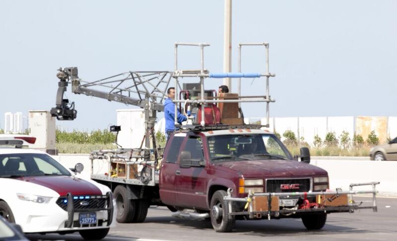A camera crew sits on the back of a truck on Sheikh Zayed Street, near Sheikh Zayed Bridge, in Abu Dhabi. Mohammed Salmeen Al Neyadi /The National