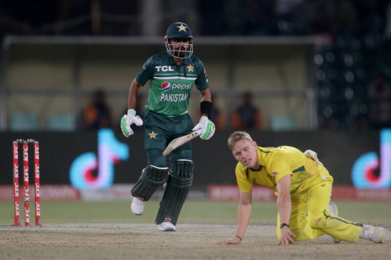 Babar Azam, left, takes a run while Australia's Nathan Ellis looks on. AP