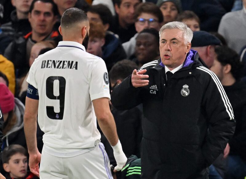 Real Madrid manager Carlo Ancelotti talks to striker Karim Benzema. AFP