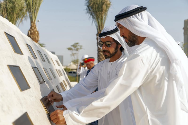 MAHWI, UNITED ARAB EMIRATES - September 04, 2019: HH Sheikh Khalifa bin Tahnoon bin Mohamed Al Nahyan, Director of the Martyrs' Families' Affairs Office of the Abu Dhabi Crown Prince Court (2nd R) and HE Mohamed Mubarak Al Mazrouei, Undersecretary of the Crown Prince Court of Abu Dhabi (R), place a memorial plaque during the inauguration of the Presidential Guard Martyrs Park, at Mahwi Military Camp. 

( Rashed Al Mansoori / Ministry of Presidential Affairs )
---