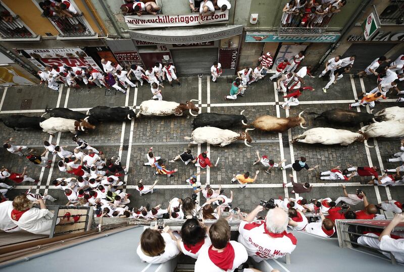 Mozos or runners try to avoid the bulls of the Puerto de San Lorenzo bull ranch during the traditional San Fermin bull run through Estafeta Street in Pamplona, Spain. EPA