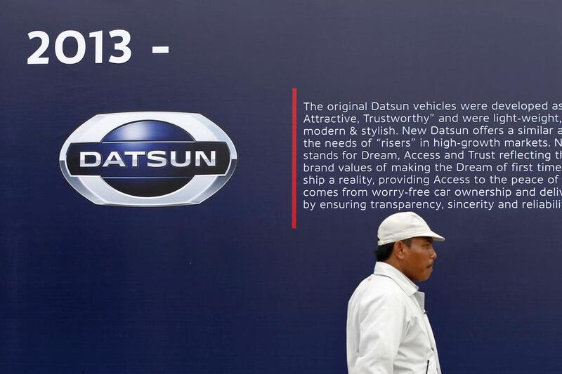 A worker walks near a Datsun logo at a Nissan Indonesia factory in Purwakarta, Indonesia. Beawiharta / Reuters