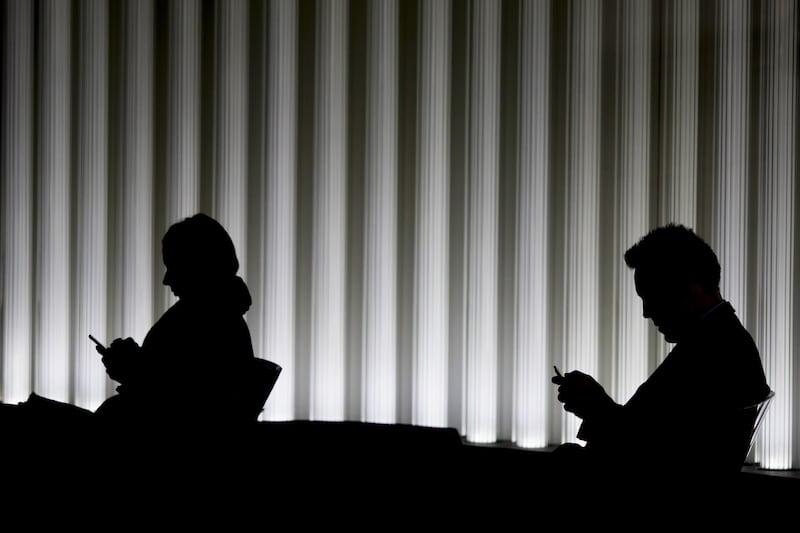 City workers use smartphones inside an office in the City of London, U.K., on Monday. Oct. 30, 2017. The Bank of England may raise interest rates this week for the first time in more than a decade, but that won’t be enough to buoy the pound, strategists say. Photographer: Jason Alden/Bloomberg