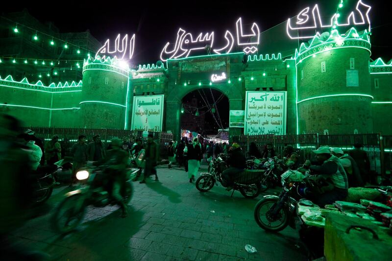The main gate of the old city of Sanaa, Yemen, is illuminated with green lights and decorated with neon words reading in Arabic 'At thy pleasure, O Allah's Apostle' ahead of celebrations of the birthday of the Prophet Muhammad. EPA