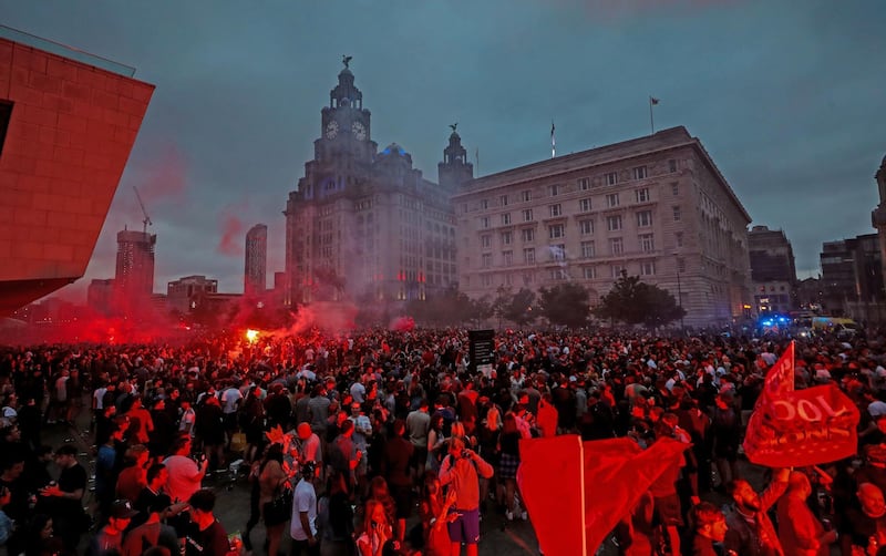 Liverpool fans let off flares outside the Liver Building in Liverpool. PA