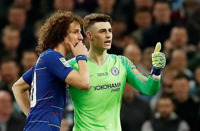 Kepa gestures he is ok after he is called to be substituted off as David Luiz talks to him. Reuters