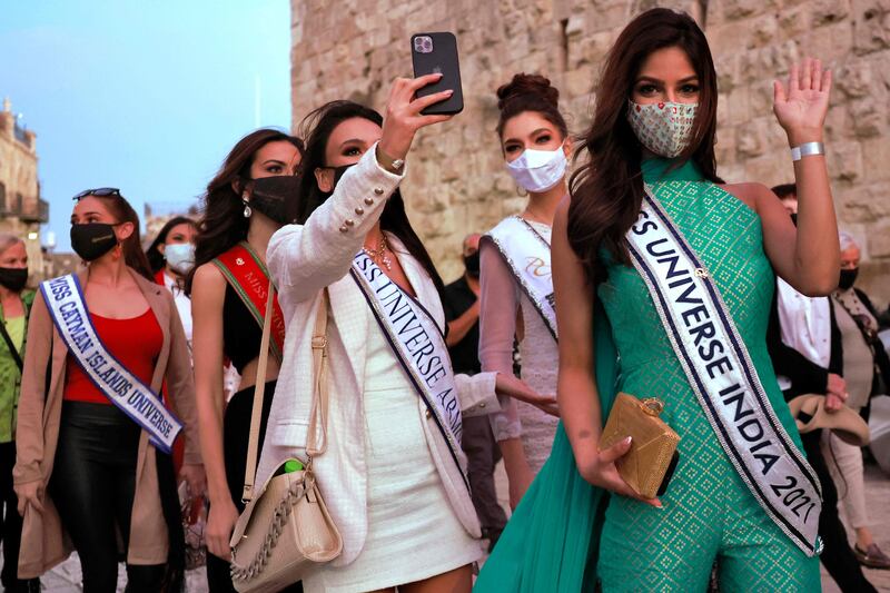 Contestants of the Miss Universe 2021 pageant take a selfie during a visit to the Tower of David Museum in the ancient citadel of Jerusalem near the Jaffa Gate entrance to Jerusalem's Old City, on November 30, 2021. AFP