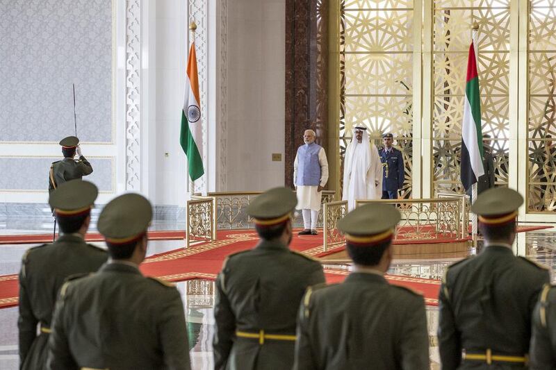Sheikh Mohammed bin Zayed and Mr Modi, stand for the national anthem during a reception at the Presidential Airport. Ryan Carter / Crown Prince Court - Abu Dhabi