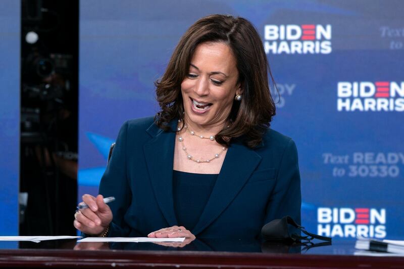 Democratic presidential candidate former Vice President Joe Biden's running mate Sen. Kamala Harris, D-Calif., signs required documents for receiving the Democratic nomination for President and Vice President of the United States in Wilmington, Del., Friday, Aug. 14, 2020. (AP Photo/Carolyn Kaster)