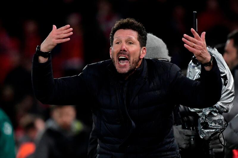 (FILES) In this file photo taken on March 11, 2020 Atletico Madrid's Argentinian coach Diego Simeone reacts after Atletico Madrid's Spanish striker Alvaro Morata scores his team's third goal during the UEFA Champions league Round of 16 second leg football match between Liverpool and Atletico Madrid at Anfield in Liverpool, north west England. Atletico Madrid's Argentinian coach Diego Simeone has tested positive for COVID-19 the club announced on September 12, 2020.  / AFP / JAVIER SORIANO
