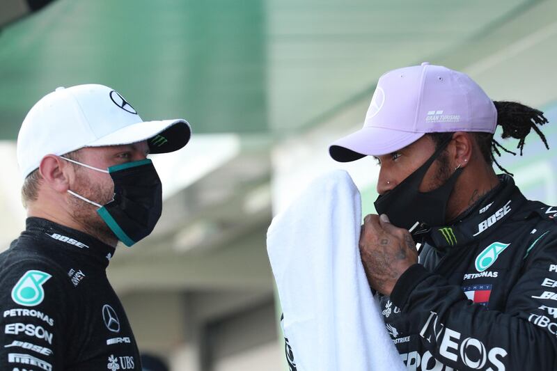 epa08605517 British Formula One driver Lewis Hamilton of Mercedes-AMG Petronas (R) and Finnish Formula One driver Valtteri Bottas of Mercedes-AMG Petronas (L) after the qualifying session of the Formula One Grand Prix of Spain at the Circuit de Barcelona-Catalunya in Montmelo, Spain, 15 August 2020. Lewis Hamilton took pole position while Valtteri Bottas second. The 2020 Formula One Grand Prix of Spain will take place on 16 August 2020.  EPA/Albert Gea / Pool