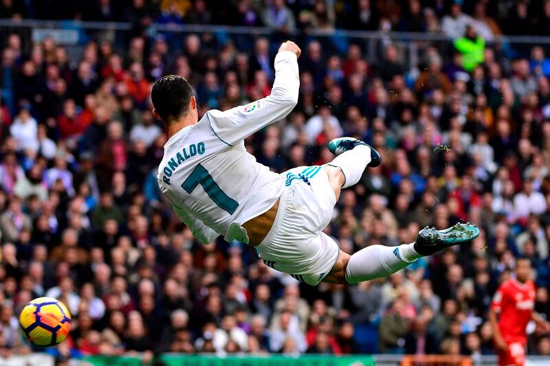 Real Madrid's Portuguese forward Cristiano Ronaldo controls the ball during the Spanish league football match between Real Madrid and Sevilla at the Santiago Bernabeu Stadium in Madrid. Pierre-Philippe Marcou / AFP Photo