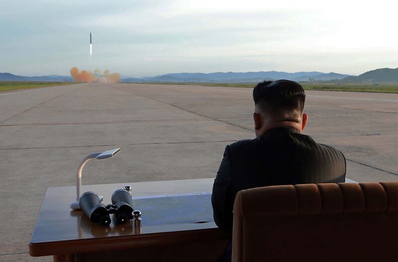 Kim Jong-un inspects a launch drill of the medium and long-range strategic ballistic rocket Hwasong-12 at an undisclosed location in September 2017. KCNA / AFP