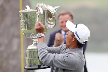 Collin Morikawa reacts as the lid to the Wanamaker Trophy falls off during the trophy presentation. AFP