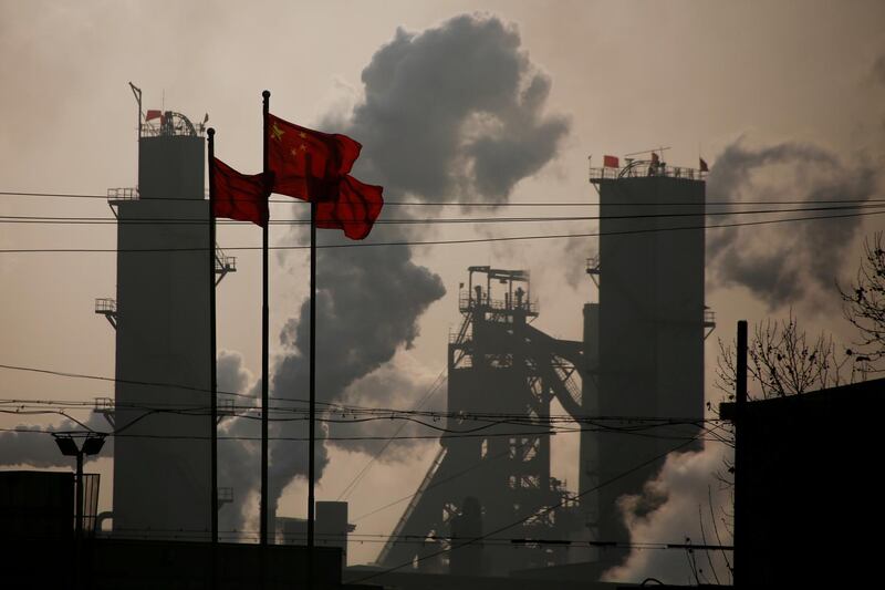 FILE PHOTO - Chinese national flags are flying near a steel factory in Wu'an, Hebei province, China, February 23, 2017.  REUTERS/Thomas Peter/File Photo   GLOBAL BUSINESS WEEK AHEAD